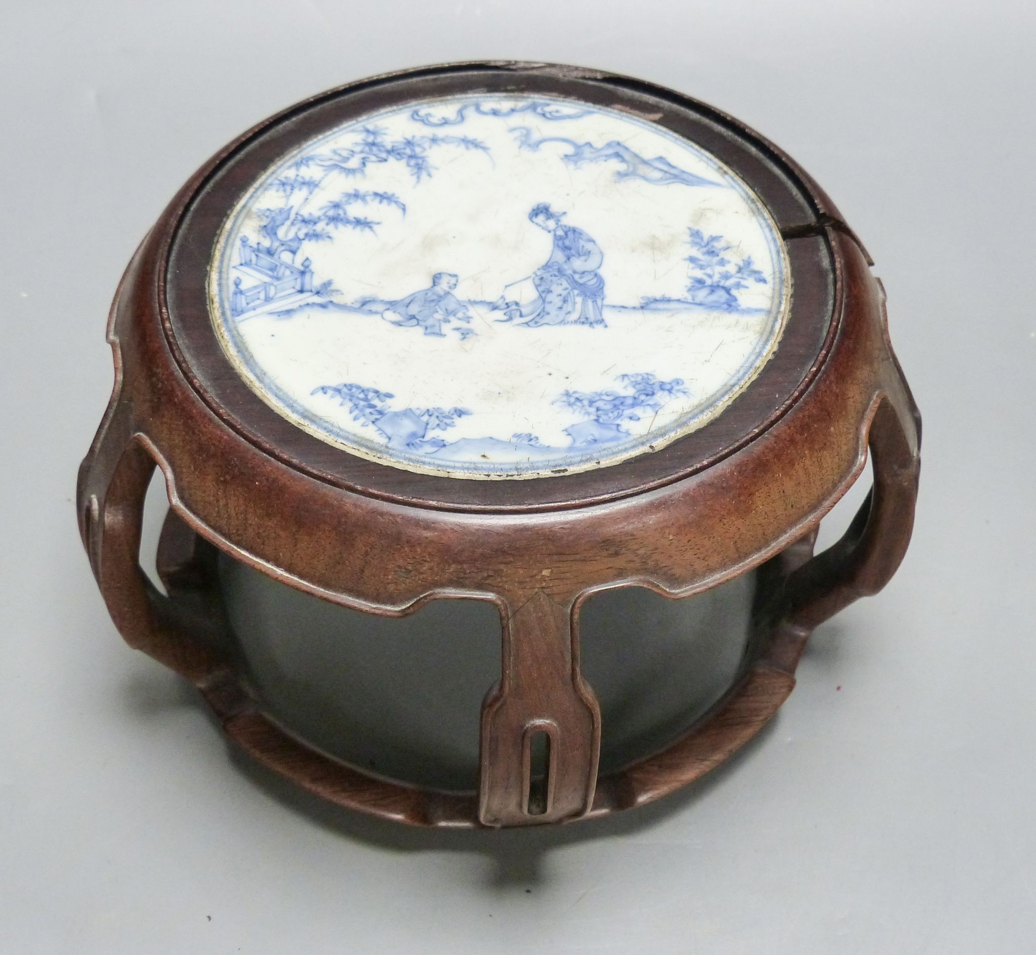 A 19th century Chinese blue and white circular tile inset hongmu stand, 22cm